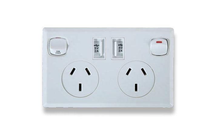 White dual power outlet with USB ports and switches, a unique household item found in specific countries only.