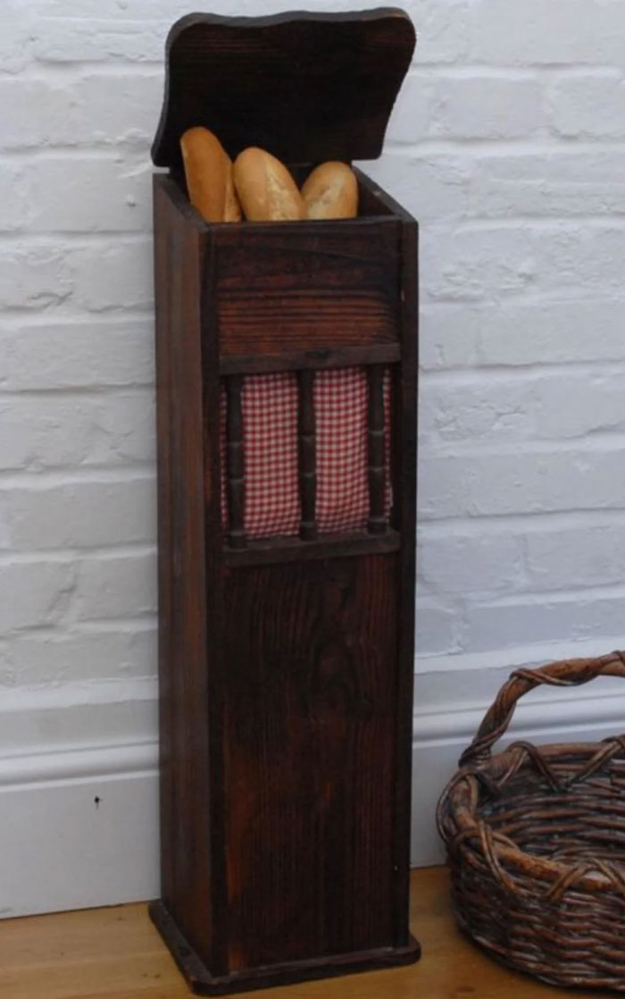 Wooden bread bin with fabric-lined opening, a unique household item shared by 100 people from different countries.