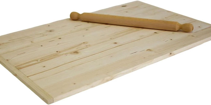 Wooden rolling pin and board, a unique household item shared by people from specific countries and cultures.
