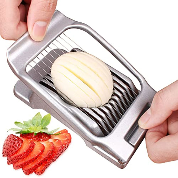 Handheld household item slicing a boiled egg with uniform metal blades, showcasing unique country-specific kitchen tool use.