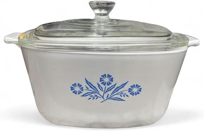 White glass casserole dish with a clear lid and blue floral design, a unique household item shared by 100 people globally.