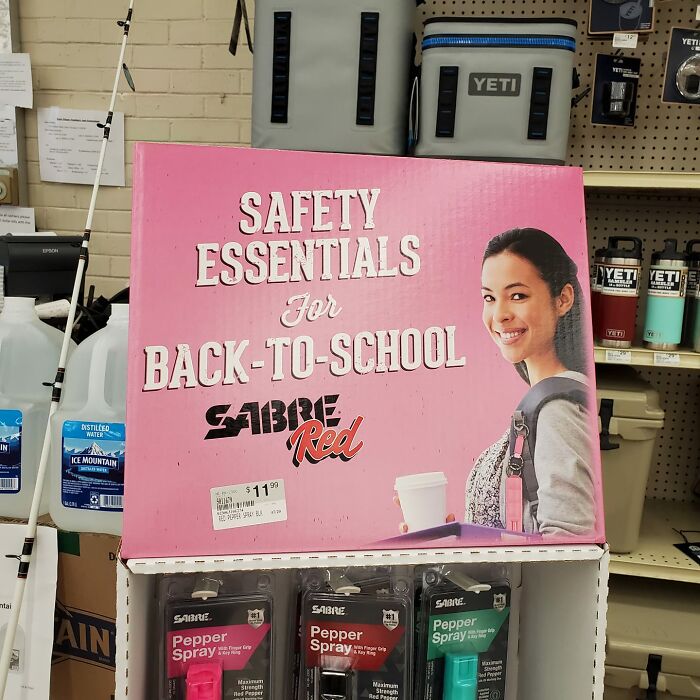 Display of safety essentials including pepper spray for back-to-school, highlighting products in a retail store setting.