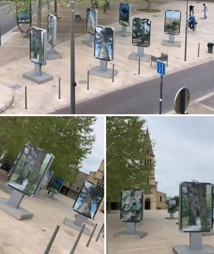 Outdoor street art installation with multiple digital screens showing nature scenes, highlighting dystopia and weirdly normal days.