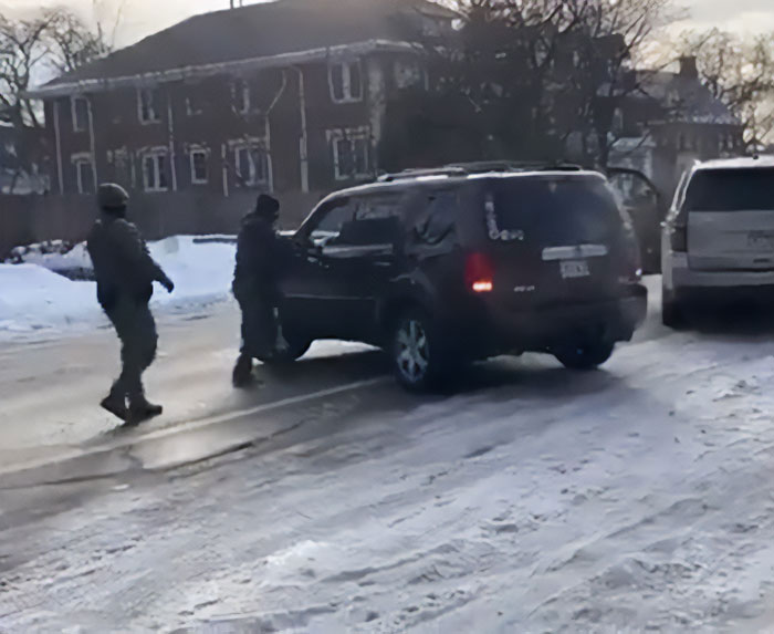 ICE agents approach a black SUV on a snowy street during a law enforcement operation involving a slain mother case. ICE agents approach a black SUV on a snowy street during a law enforcement operation involving a slain mother case.
