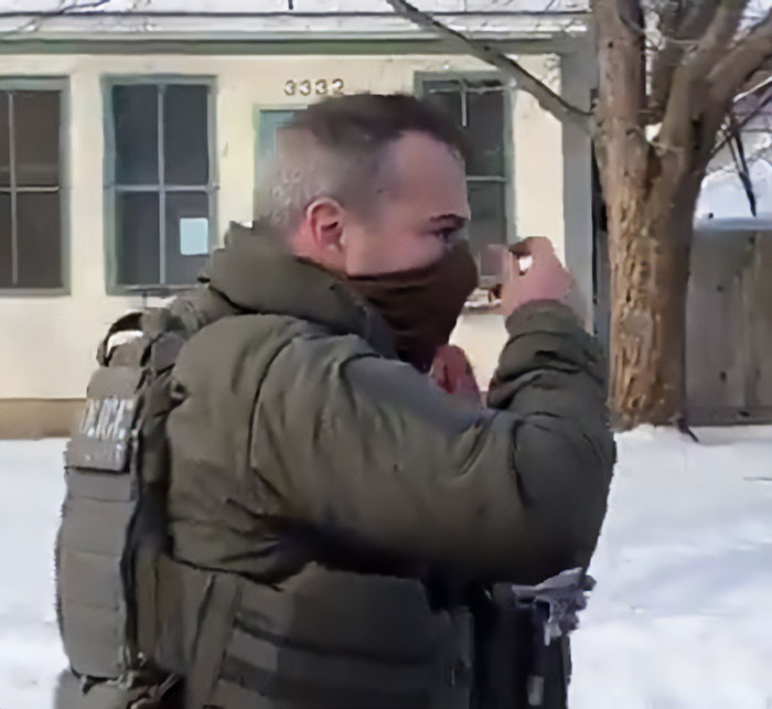 ICE officer in tactical gear outside a house in Minneapolis near the site involving a mom of a 6-year-old slain in her car. ICE officer in tactical gear outside a house in Minneapolis near the site involving a mom of a 6-year-old slain in her car.