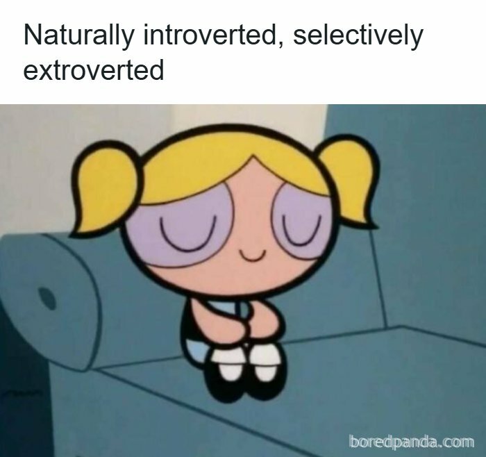 Cartoon character sitting on couch with caption about being naturally introverted and selectively extroverted humor coping mechanism humor post.