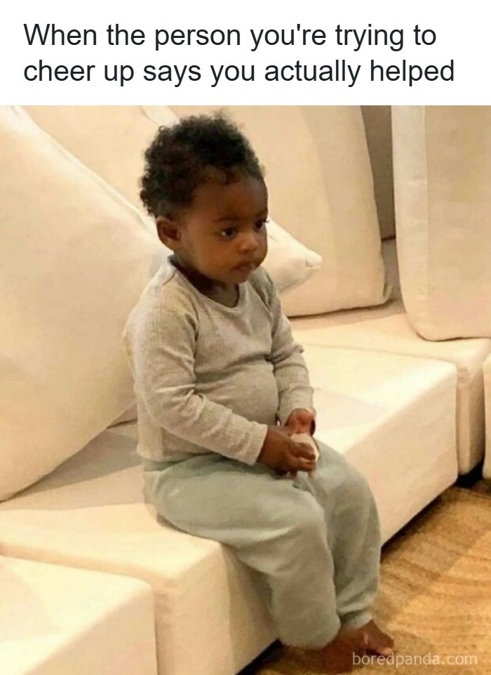 Toddler sitting on a couch looking bored with caption about doing nothing despite having many tasks, humor coping mechanism post.