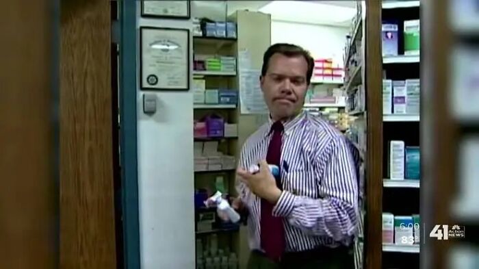 A doctor in an office holding multiple medication bottles, suggesting unethical behavior with a patient.