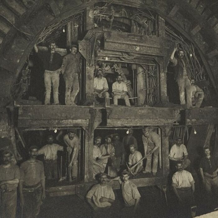 Group of miners working underground in a historic photograph showing the sad and sometimes horrific history of humanity.