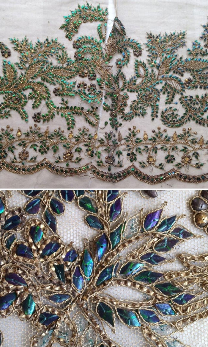 Victorian era embroidery with intricate gold thread and iridescent green and blue decorative details on fabric.