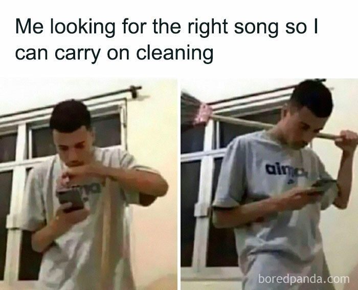 Person looking at phone while holding a broom, relatable meme about introvert life and finding the right song for cleaning.