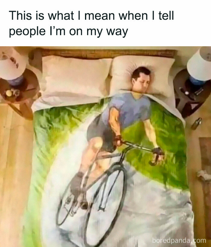 Man lying in bed covered by a blanket showing a cyclist image, illustrating relatable introvert life memes humor.
