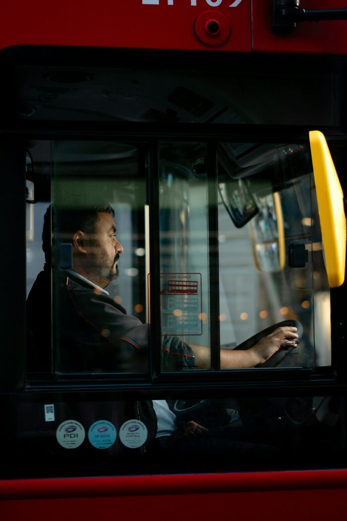 Man focused driving bus, illustrating unusual teacher behavior witnessed in class through metaphorical imagery.