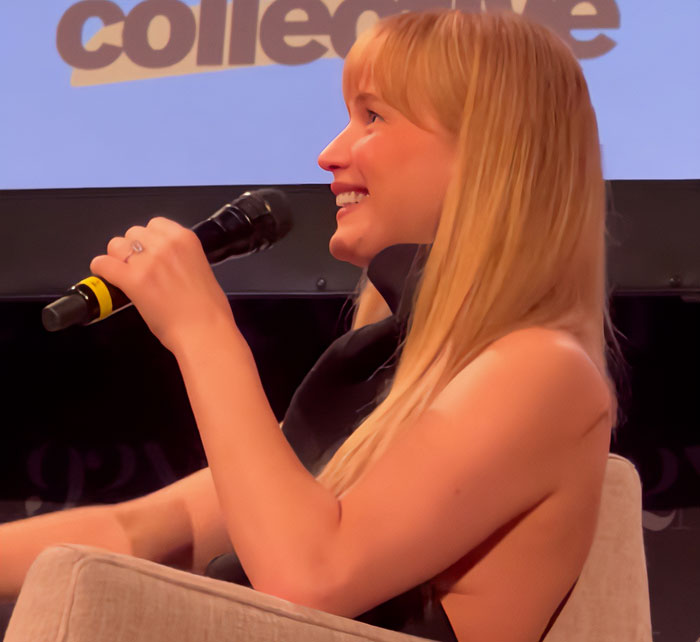 A blonde woman holding a microphone, smiling during a discussion about Jennifer Lawrence sparking fury over pet rehoming. A blonde woman holding a microphone, smiling during a discussion about Jennifer Lawrence sparking fury over pet rehoming.