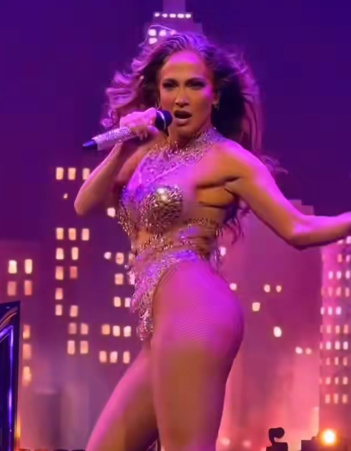 Jennifer Lopez performing on stage in a sparkly outfit, going viral for responding to dress her age comments. Jennifer Lopez performing on stage in a sparkly outfit, going viral for responding to dress her age comments.