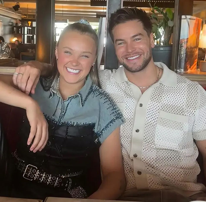 JoJo Siwa with a man, both smiling at a restaurant, highlighting her massive transformation and latest confession news.