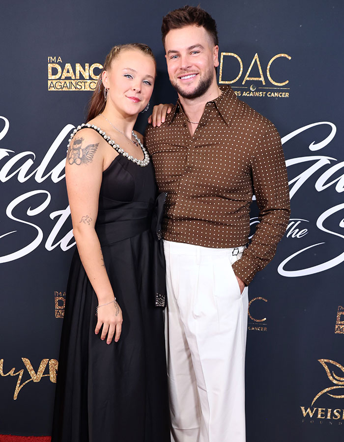 JoJo Siwa and companion posing at a gala event highlighting JoJo Siwa's latest confession and massive transformation. JoJo Siwa and companion posing at a gala event highlighting JoJo Siwa's latest confession and massive transformation.