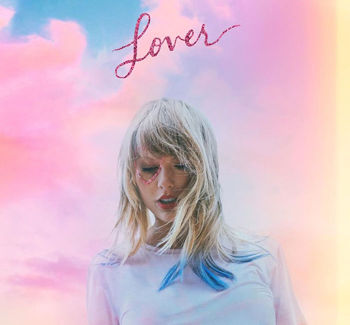 Female music artist with colorful hair and heart makeup under soft pastel sky, reflecting Grammy snubs impact on fans.