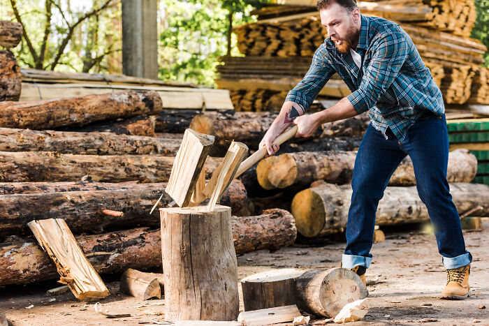 A man chopping wood outdoors with an axe, illustrating misconceptions about women and changing gender roles.