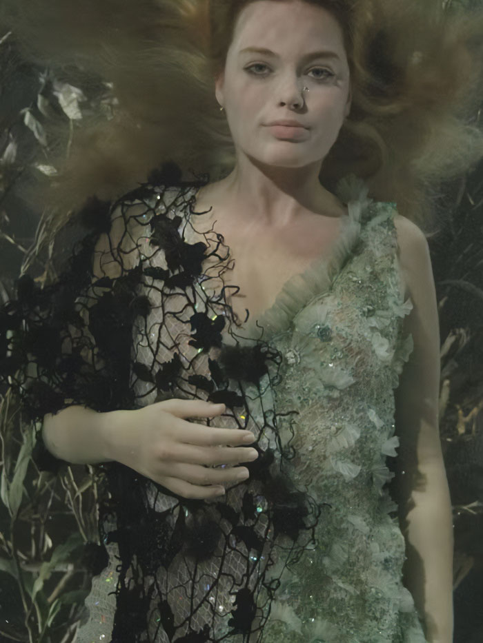 Margot Robbie in a detailed floral dress posed underwater for a controversial underwater cover shoot. Margot Robbie in a detailed floral dress posed underwater for a controversial underwater cover shoot.