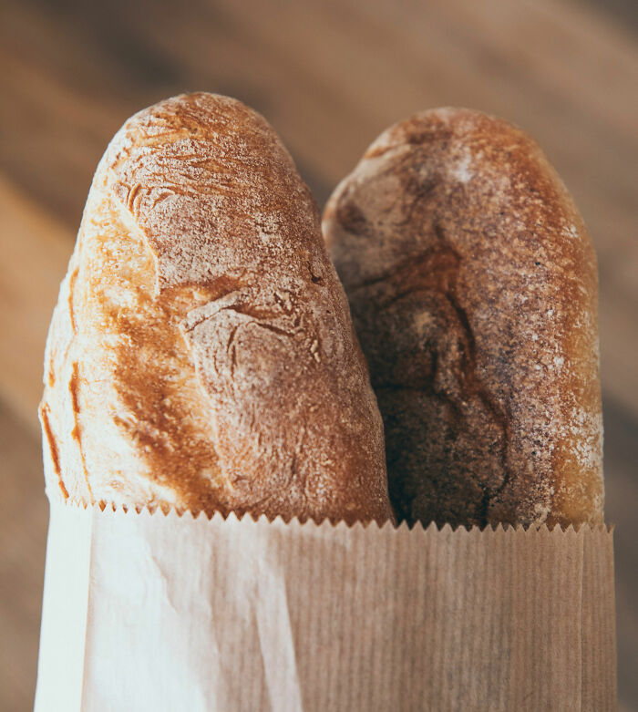 Two loaves of bread in a paper bag symbolizing petty fights between couples over the Christmas period.