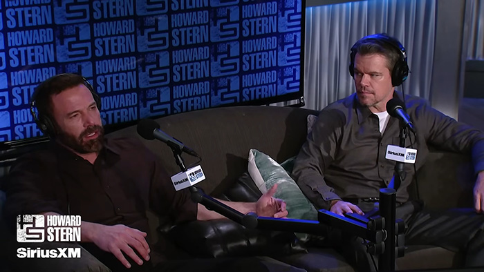 Matt Damon in a radio interview at Howard Stern show discussing career moments with focused expressions and casual attire. Matt Damon in a radio interview at Howard Stern show discussing career moments with focused expressions and casual attire.