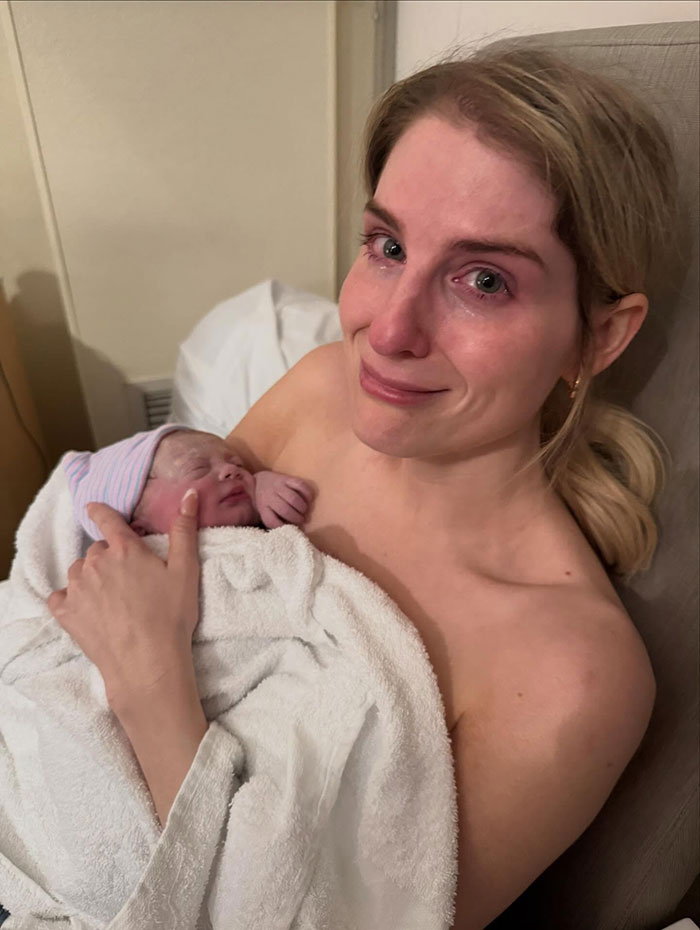 Woman holding newborn baby wrapped in white towel, emotional moment captured with secret surrogate baby reveal. Woman holding newborn baby wrapped in white towel, emotional moment captured with secret surrogate baby reveal.