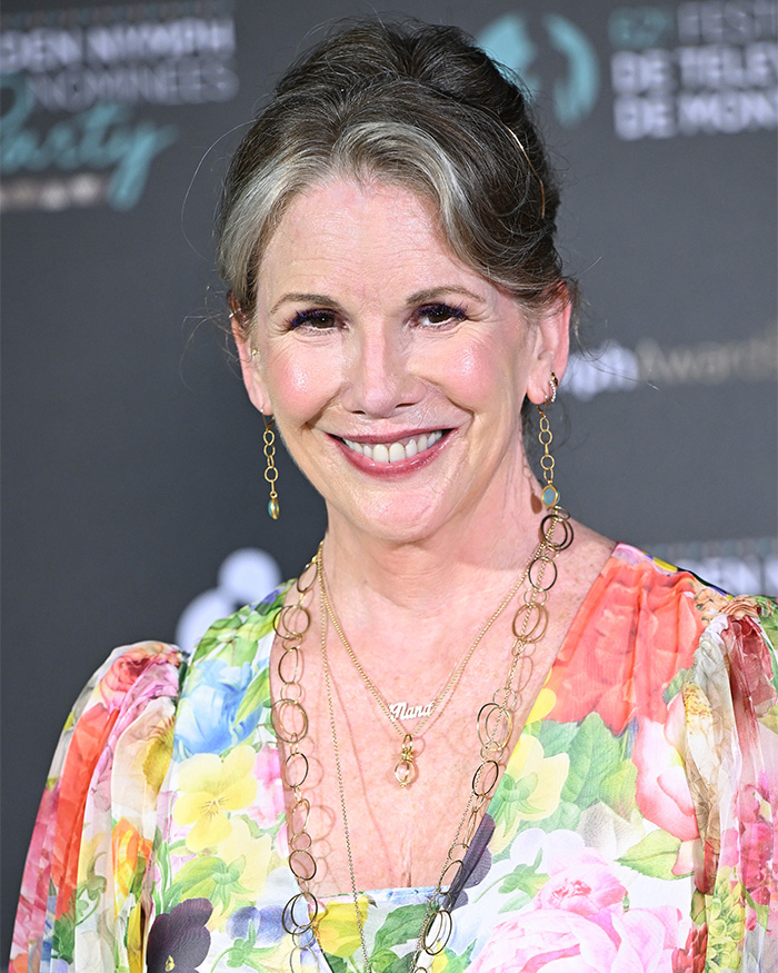 Melissa Gilbert smiling at event, wearing floral dress and gold jewelry, related to letter about husband Timothy Busfield controversy.