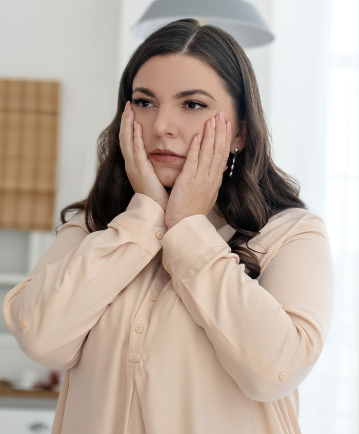 Upset mom storms off, holding her face in a kitchen, tense moment after mother-in-law tried to take over feeding Upset mom storms off, holding her face in a kitchen, tense moment after mother-in-law tried to take over feeding