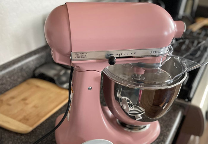 Pink KitchenAid Artisan stand mixer on kitchen counter, highlighting family moments and gift ideas for mom’s birthday.