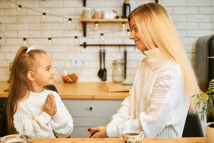 Guest mom rearranges food and gently corrects child during a b-day party, taking control of the house atmosphere. Guest mom rearranges food and gently corrects child during a b-day party, taking control of the house atmosphere.