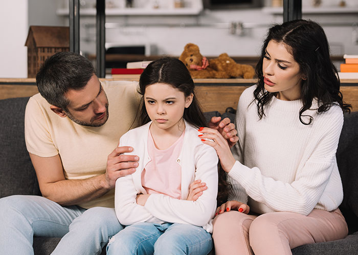 A mother blames her daughter for picking dad during divorce, causing tension and refusal to involve her in family life.