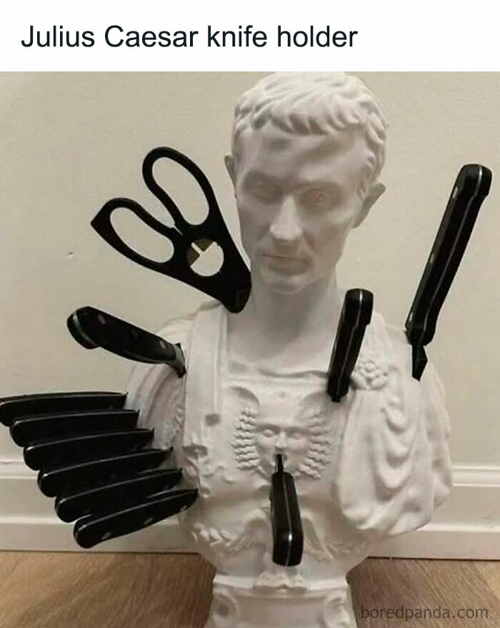Bust of Julius Caesar used as a knife holder with multiple knives and scissors inserted, a funny movie meme concept.