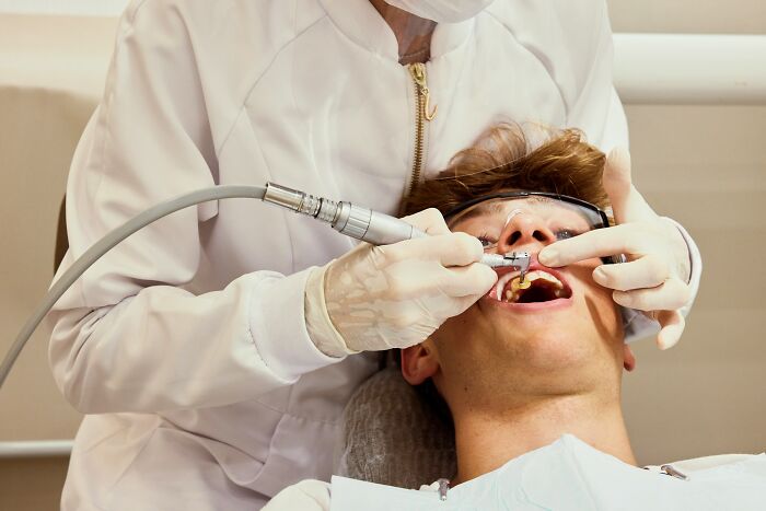 Doctor performing dental procedure on patient, highlighting examples of a doctor doing something unethical with a patient.