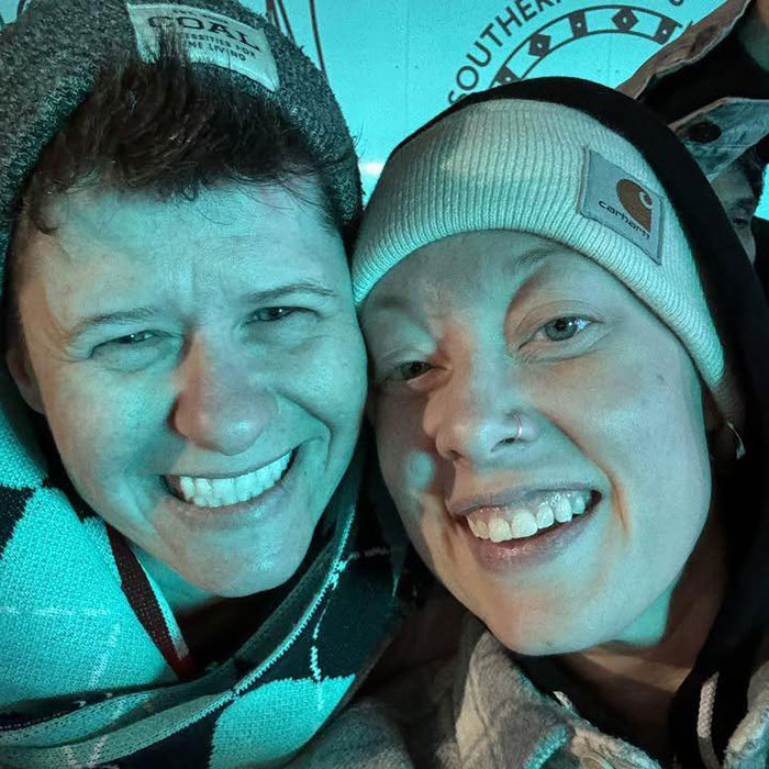 Father of ICE agent who slew Renee Nicole Good pictured with a smiling woman wearing winter hats in close-up. Father of ICE agent who slew Renee Nicole Good pictured with a smiling woman wearing winter hats in close-up.