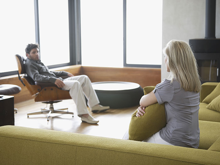 Man demands paternity test for 3-year-old son while woman suggests therapy in modern living room debate. Man demands paternity test for 3-year-old son while woman suggests therapy in modern living room debate.