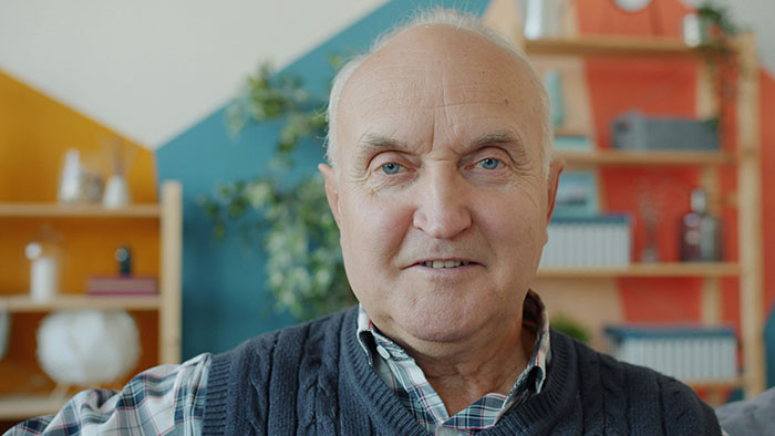 Bald and divorced man with a serious expression in a cozy room, shaming nephew for long hair and cooking for girlfriend. Bald and divorced man with a serious expression in a cozy room, shaming nephew for long hair and cooking for girlfriend.