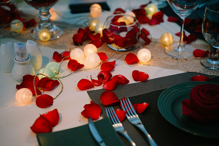 Romantic dinner table with rose petals and fairy lights, illustrating cooking and relationship themes for bald and divorced man story. Romantic dinner table with rose petals and fairy lights, illustrating cooking and relationship themes for bald and divorced man story.