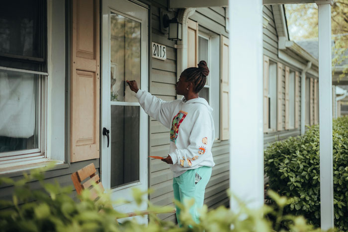 Person standing at a neighbor's door, symbolizing tension over parking place hijacked despite refusal to switch spots. Person standing at a neighbor's door, symbolizing tension over parking place hijacked despite refusal to switch spots.