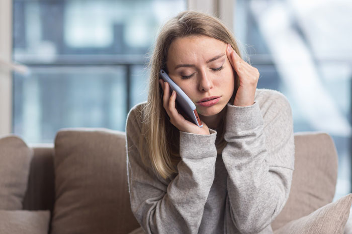 Young woman looking worried while talking on the phone, illustrating partner sleep called ambulance myself situation. Young woman looking worried while talking on the phone, illustrating partner sleep called ambulance myself situation.