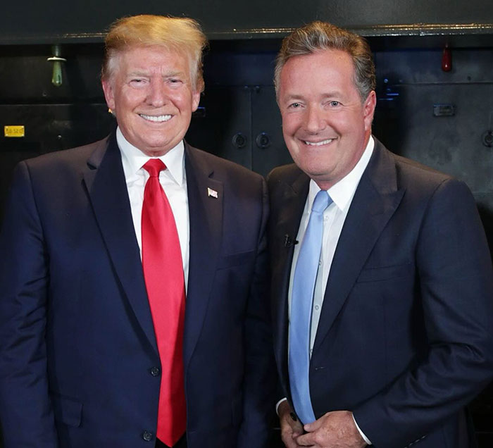 Donald Trump and Piers Morgan smiling together, with Piers Morgan blaming Trump for serious injury incident. Donald Trump and Piers Morgan smiling together, with Piers Morgan blaming Trump for serious injury incident.