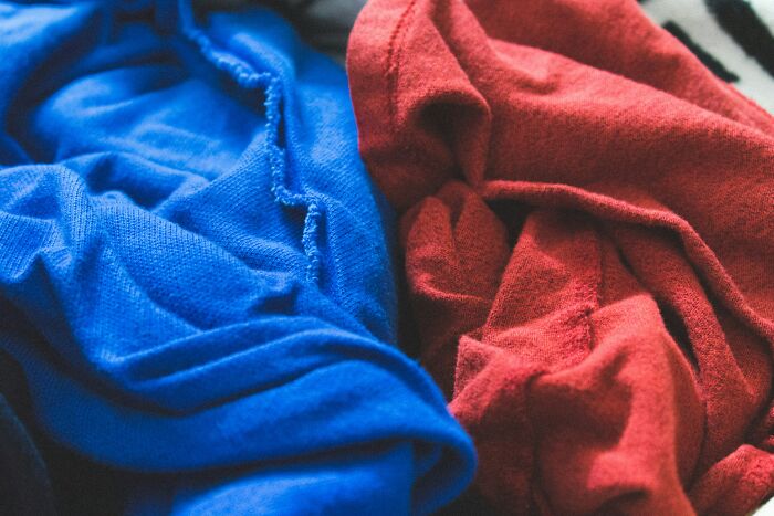 Close-up of wrinkled red and blue fabric, illustrating real-life cheat codes for everyday hacks and solutions.