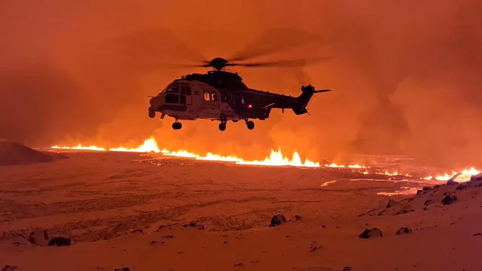 Helicopter flying over wildfire in a country landscape, capturing a photo that hits hard with impactful scenes.