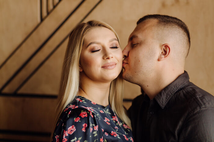 Young couple sharing a tender moment indoors, illustrating emotions often linked to people sharing wildest ways found out cheating.