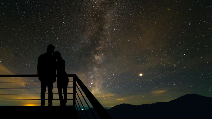 Silhouetted couple stargazing under the Milky Way, moments people faced an unbelievable night sky