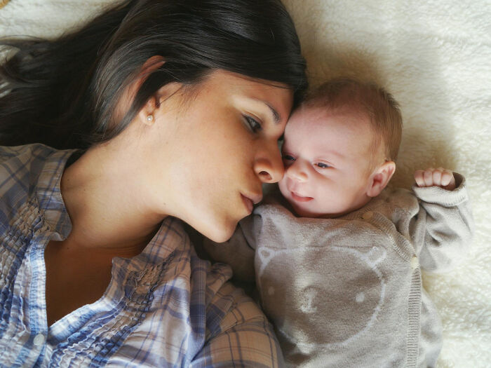 Mother and newborn lying close, tender bonding moment, Moments People Faced
