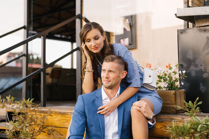 Couple in blue outfits sitting outdoors, reflecting on strange tales of folks who morphed into something new.