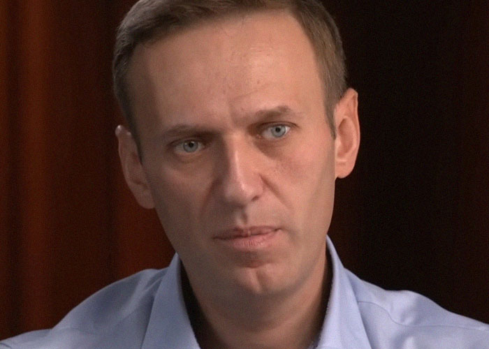 Close-up of a man with a serious expression, representing celebrity passings that people still question as random.