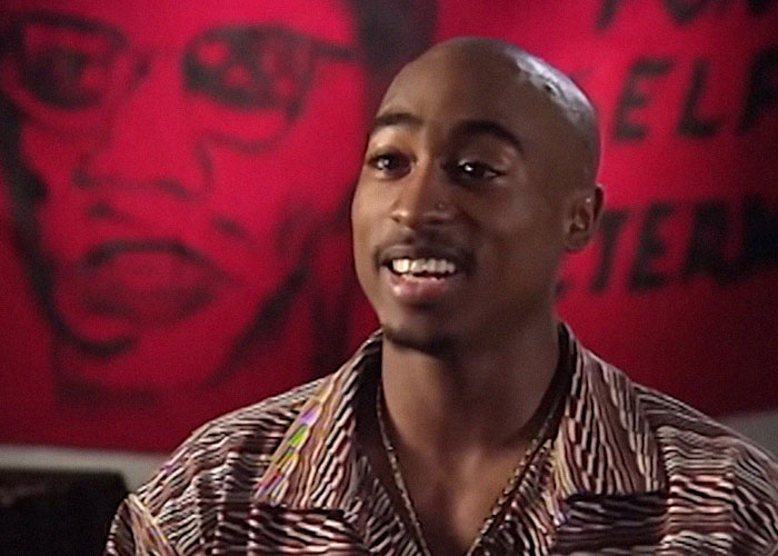 African American male celebrity speaking on camera with a red background, related to celebrity passings and rumors.