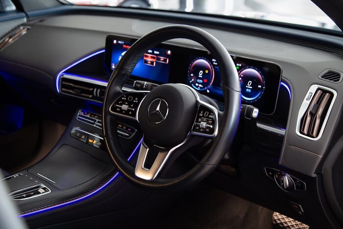 Luxury car interior with sleek dashboard and digital displays, illustrating things that shocked people after prison release.